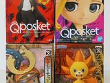 three boxes of anime action figures sitting on top of a table