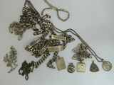 a lot of silver jewelry on a white surface