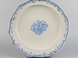underside view of a blue and white plate with a floral design