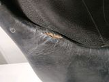 the bottom of a black purse with a hole in the middle of it