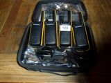 several cell phones are in a black case on a wooden table