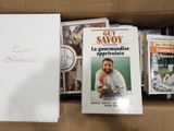 une boîte remplie de livres et de DVD posée sur une table