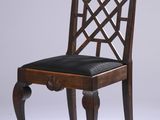 a wooden chair with a black seat on a white background