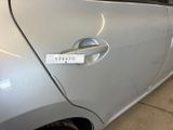 a close up of a car door handle with a sticker on it