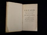 a book open on a black surface with a black background