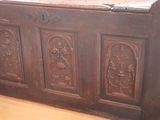 a wooden chest with carvings on it in a room