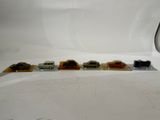 five toy cars that are lined up on a white surface