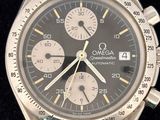 an image of a close up of a wrist watch on a black surface