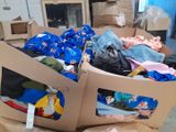a cardboard box filled with clothes in a warehouse