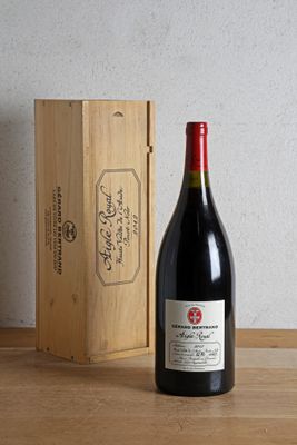 a bottle of wine sitting next to a wooden box
