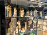 many figurines of people in a glass case