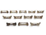 un ensemble de neuf barrettes en laiton ancien sur fond blanc