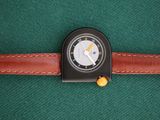 an image of a close up of a wrist watch on a green surface