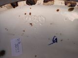 a close up of a white plate with blue writing on it