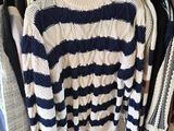 a rack of sweaters and sweaters in a clothing store