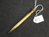 a pen with a tag attached to it sitting on a table