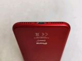 the back view of a red iphone with a black stand