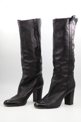 bottes en cuir noir à talons hauts avec des fermetures éclair sur le côté