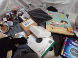 a pile of clothing and other items on the floor