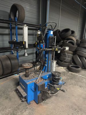 a machine that is sitting in front of a pile of tires