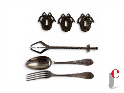four spoons, a fork, and a knife on a white surface
