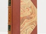 an old book with a marbled cover and a leather binding