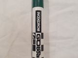 a close up of a green marker pen on a white sheet