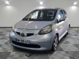 a picture of a silver toyota aygo parked on a checkered floor