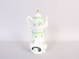 an image of a white and green tea pot on a white table