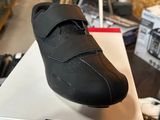 someone is holding a box with a pair of shoes on it