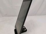 a tablet computer sitting on a stand on a white surface