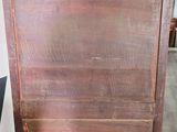 an old wooden chest of drawers sitting on top of a hard wood floor