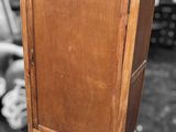 a small wooden cabinet with a door on top of it