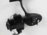a close up of a fishing reel on a white surface