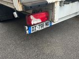 a white truck with a red light on the back of it