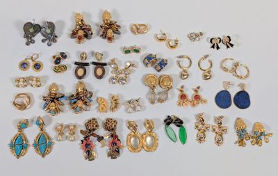 many different types of earrings on a white surface