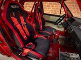 a red and black car with two seats in it