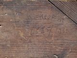 a close up of a piece of wood with writing on it