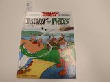 the cover of asterix and the tikes comic book on a table