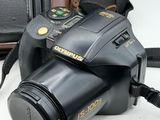 a black camera with a black strap and a brown camera case