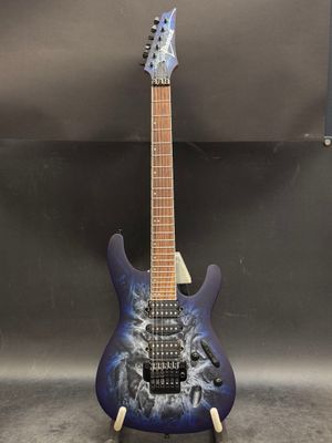 a blue electric guitar with a black and white design on it