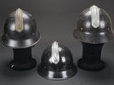 three helmets sitting on top of each other on a table