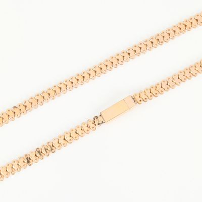 a gold chain with a clasp on a white background