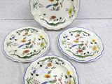three plates with flowers and leaves on them on a table