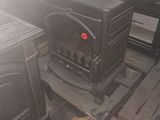 a stove that is sitting in the middle of a room