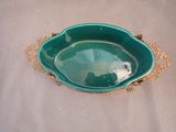 a green bowl sitting on top of a white table