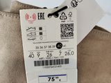 someone is holding a pair of shoes with a price tag on them
