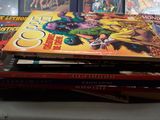 a lot of comic books stacked on top of each other