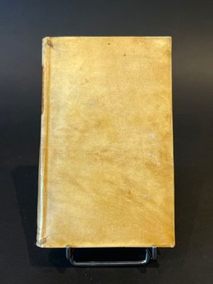 an old book sitting on top of a black table