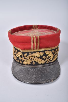 a red and black hat with gold decorations on it